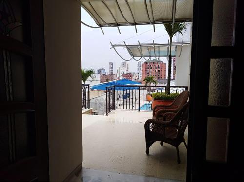 an open door to a balcony with a chair at Hotel Buena Vista in Bucaramanga