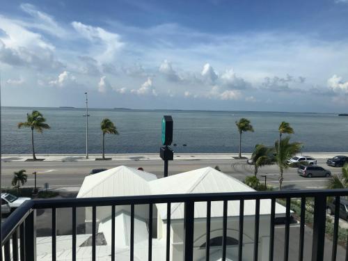 a view from a balcony of a beach with a view of the ocean at The Laureate Key West in Key West