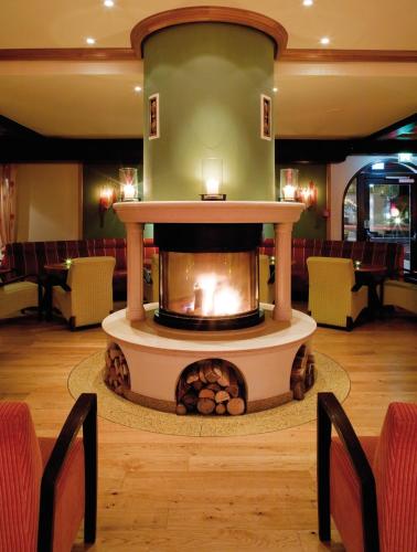a fireplace in the lobby of a restaurant at aja Fürstenhaus am Achensee in Pertisau