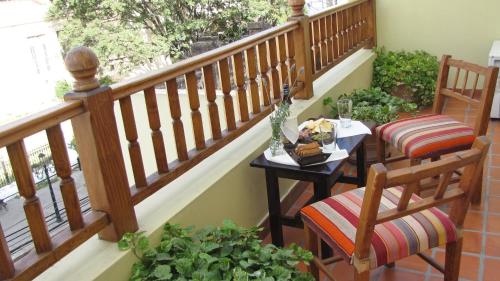 a balcony with a table and chairs and a staircase at Altos De Balcarce Hotel in Salta