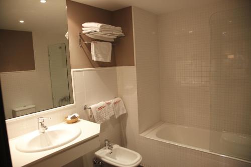 a bathroom with a sink and a toilet and a shower at Cesaraugusta in Zaragoza