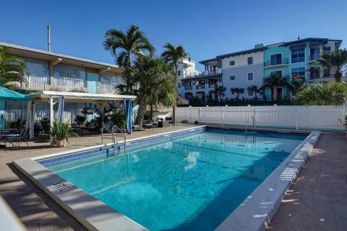 a large swimming pool in front of a building at Castle by the Sea Motel in Fort Lauderdale