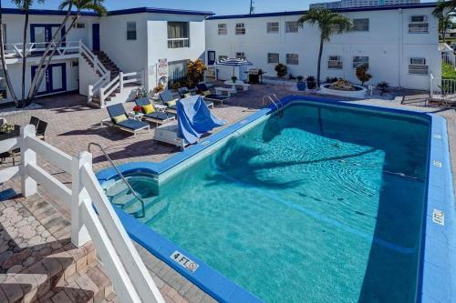 a large pool with blue water in a yard at Blue Strawberry by the Sea in Fort Lauderdale