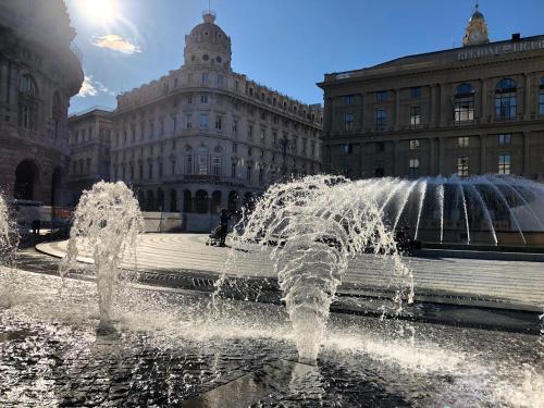 a water fountain in front of a building at B&B Piccoli Leoni in Genova