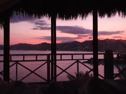 a view of a sunset from a beach house at Hotel Boutique Siete Lunas in Sayulita