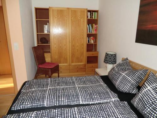 a bedroom with a bed and a book shelf at Ferienwohnung Am Wildmeisterweg in Wernigerode
