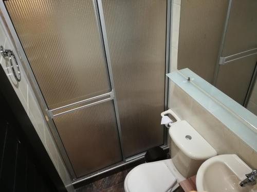 a bathroom with a shower and a toilet and a sink at Cali Home in Cali