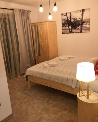 a bedroom with a bed and a cabinet and a lamp at Rezydencja Kojsowka in Witów