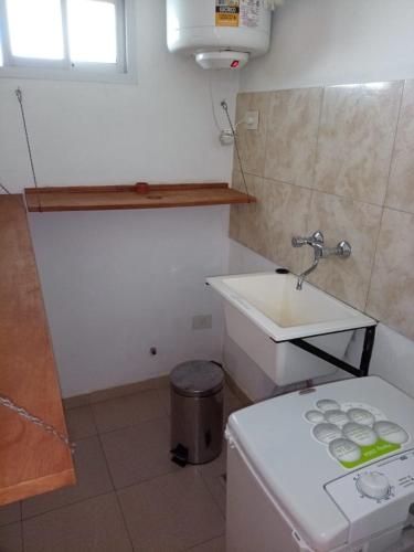 a small bathroom with a sink and a toilet at Family place in Luján