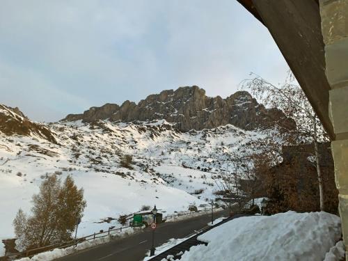 a view of a snow covered mountain with a road at Chalet Los Ibones - Lodge Formigal in Formigal