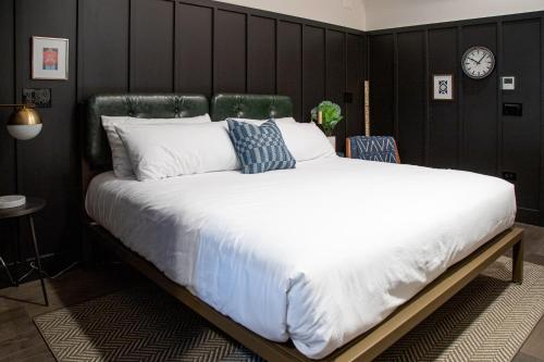 a large bed in a bedroom with a black wall at The Chicago Hotel Collection River North in Chicago