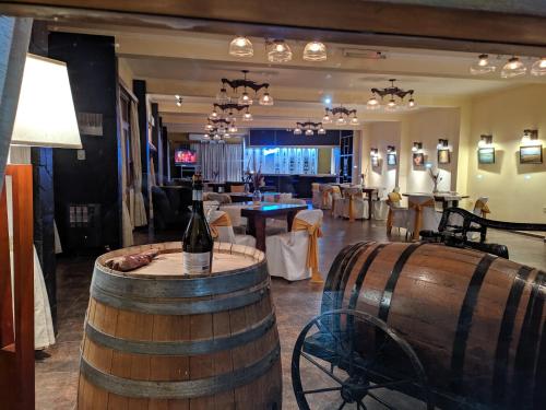 a room with two wine barrels and a restaurant at Hotel Risco Plateado Room & Suite in Malargüe