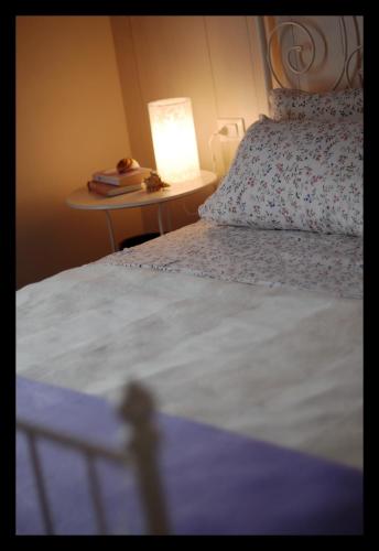a bedroom with a bed and a table with a lamp at Locanda Della Fiorina in San Felice sul Panaro