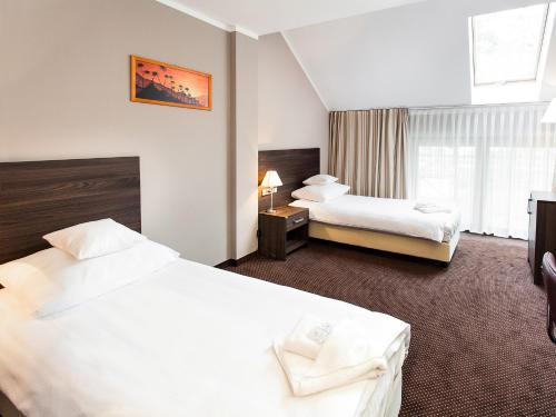 Ένα ή περισσότερα κρεβάτια σε δωμάτιο στο Hotel Viki