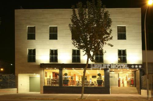 a building with a lighted store in front of it at Leflet Valme in Dos Hermanas