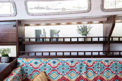 a bed in a room with two windows at Romantic Escape in Downtown St Augustine in Saint Augustine