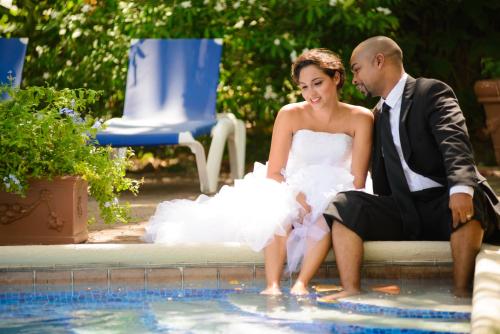 a bride and groom sitting next to a swimming pool at Terra Nova, BW Premier Collection in Kingston