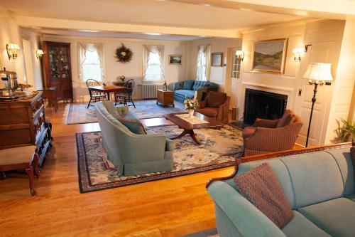 a living room filled with furniture and a fireplace at Adair Country Inn & Restaurant in Bethlehem