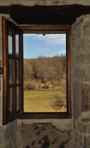 an open window with a view of a field at Gites de Combarel in Corn
