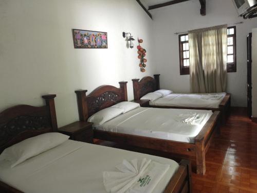 Postel nebo postele na pokoji v ubytování Hotel Campestre Mucura