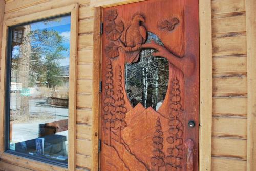 a wooden door with a dragon design on it at Double Eagle Resort and Spa in June Lake