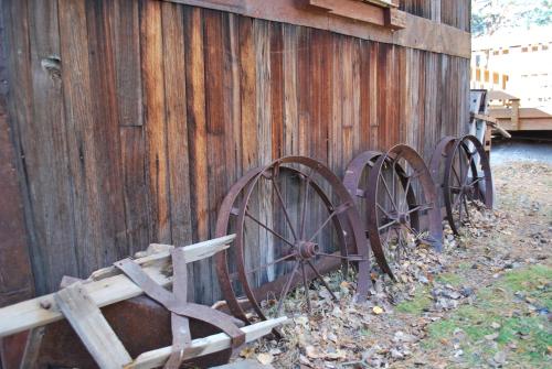 a group of old wooden wheels leaning against a fence at Double Eagle Resort and Spa in June Lake
