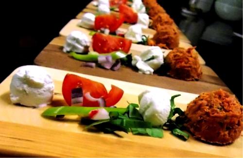 two plates of food with vegetables and cheese on them at Hotel Vineyard Inn - Szőlőskert in Nagykanizsa