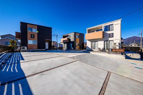 a large parking lot in front of some buildings at 21 ORIYA Mt Fuji -縁ENISHI- in Fujikawaguchiko