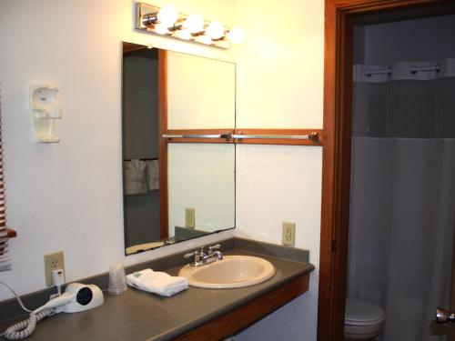 a bathroom with a sink and a mirror at Cape Hatteras Motel in Buxton