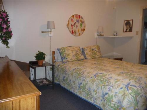 a small bedroom with a bed and a table at Florence I Condos F1705 in South Padre Island