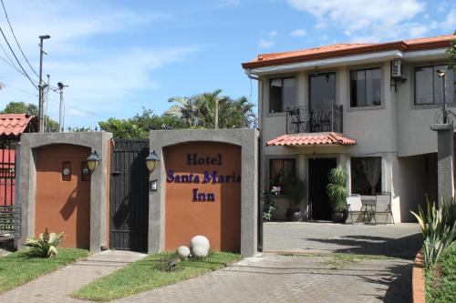 a house with a sign that reads hotel santa marta la at Hotel Santa Maria Inn in Alajuela City
