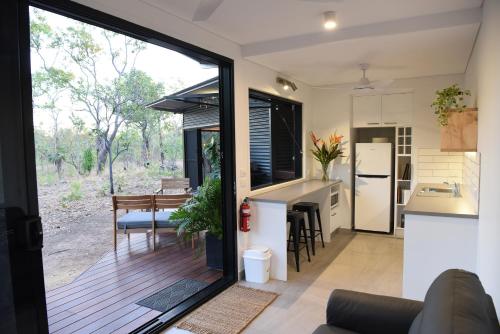 a kitchen and dining room with a sliding glass door at Hideaway Litchfield in Rakula