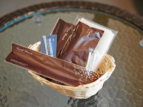 a basket of chocolate on a glass table at Crown Hotel Okinawa Annex in Okinawa City