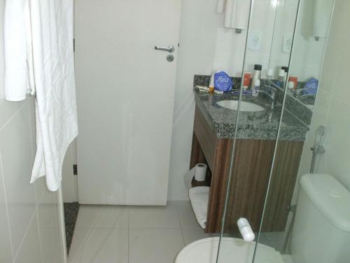 y baño con aseo, lavabo y ducha. en Apartamento Diroma Lacqua 3 en Caldas Novas