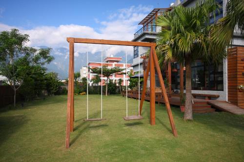 a swing set in a yard next to a building at Jimei Homestay in Jian