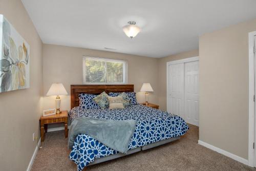 a bedroom with a bed and two lamps and a door at Pet Friendly near Garden of the Gods AF Academy in Colorado Springs