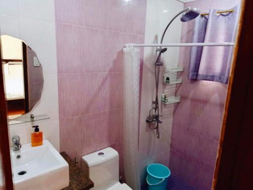 a bathroom with a toilet and a sink and a shower at AJ's Haven Homestay in Cebu City