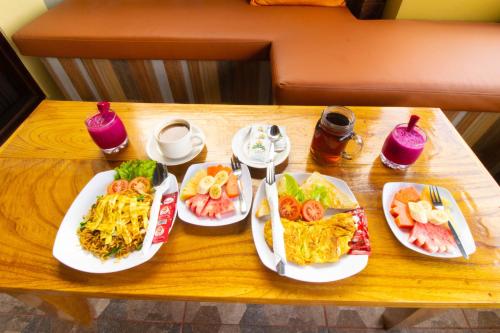 a table with three plates of food on it at Pondok Kutuh Guest House in Ubud