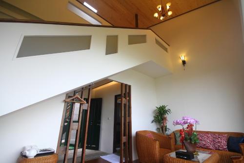 a living room with a staircase and a couch at Jimei Homestay in Jian