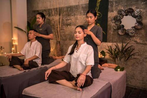 a group of people sitting on beds at The Villa by Metta in Siem Reap