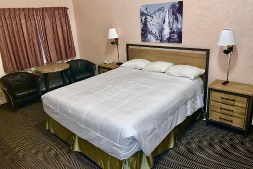 a hotel room with a large bed and a table at Yosemite View Lodge in El Portal