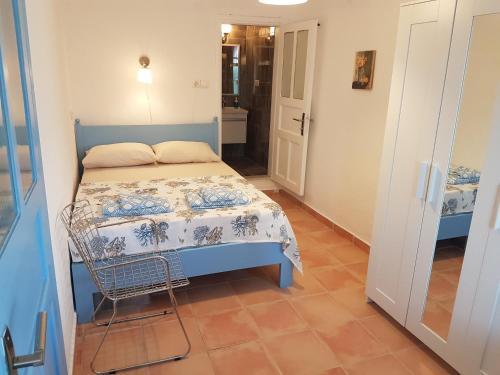 a small bedroom with a blue bed and a tiled floor at Boynuz Ağacı pansiyon in Kaleucagız