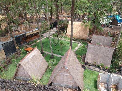 an aerial view of a garden with two huts at Triangle House and hot spring in Kintamani