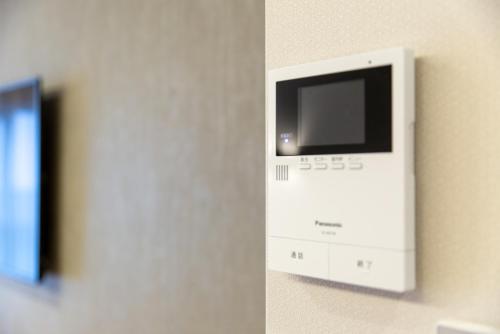 a television on a wall in a room at GRAND BASE Hiroshima Hikarimachi in Hiroshima