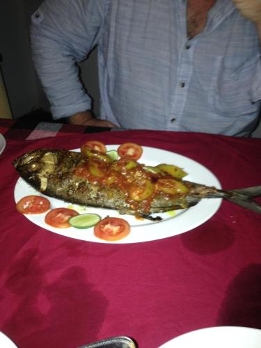 a plate of food on a table with a fish at Sunshine Cafe in Tangalle