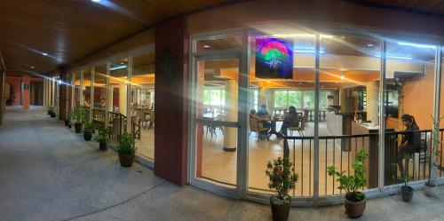 a building with glass doors and potted plants at Maharajah Hotel in Angeles