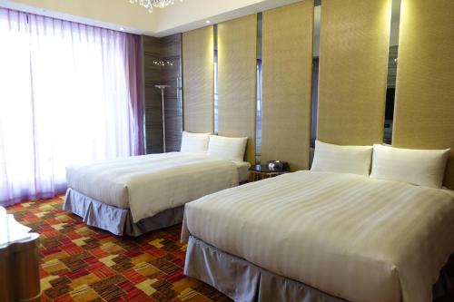 Postel nebo postele na pokoji v ubytování Sun Hao International Hotel