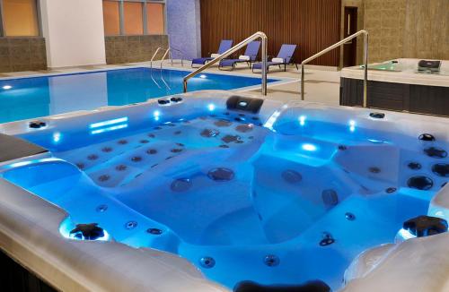 a jacuzzi tub in a hotel room at voco Al Khobar by IHG in Al Khobar