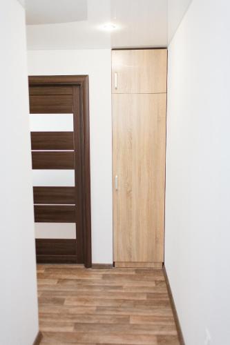an empty room with a closet and wooden doors at Apartment on Soborniy 85 in Oleksandriya