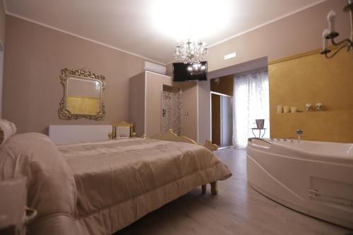 a bedroom with a bed and a bath tub at Cupido da Simona in Ostellato